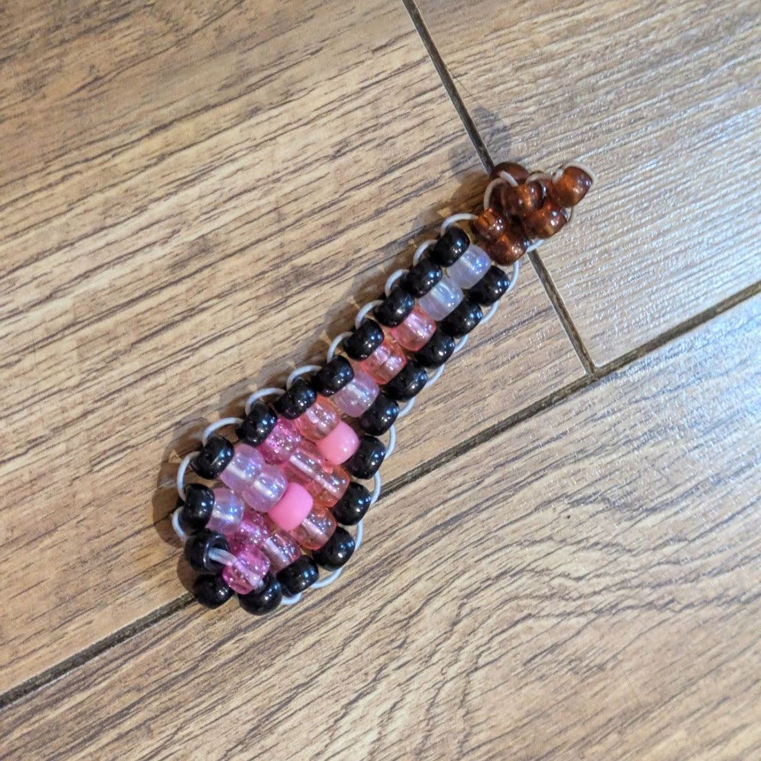 Beaded keychain/fidgit on a wooden floor