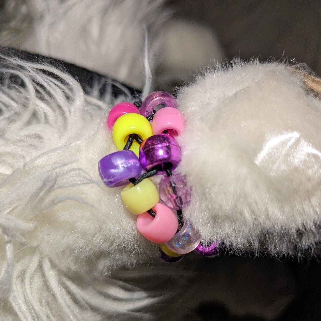 Colorful beaded bracelet on a white furry surface